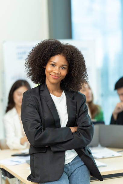 istock Business people showing team work while working in board room in office interior. People helping one of their colleague to finish new business plan. Business concept. Team work. 1419343773