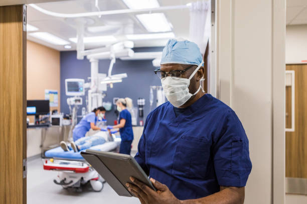 istock While nurses attend patient, doctor reviews medical record 1419346023