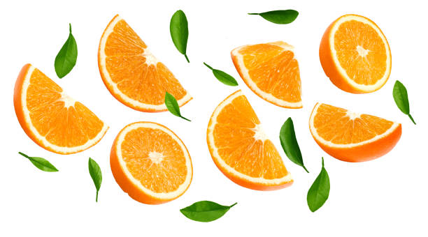 istock flying sliced oranges with green leaves isolated on white background. clipping path 1419346923