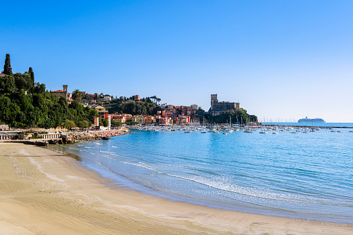 Beach of Lido di Lerici, with the castle in background. A cruise ship is moored offshore