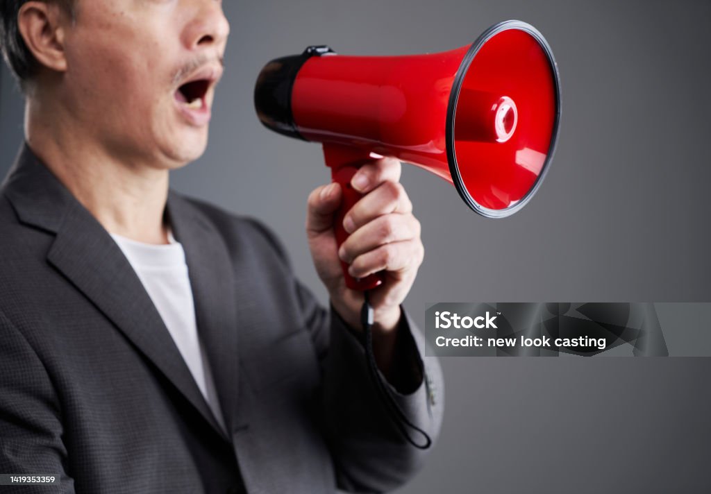chinese ethnicity businessman holding  red megaphone 55-59 Years Stock Photo