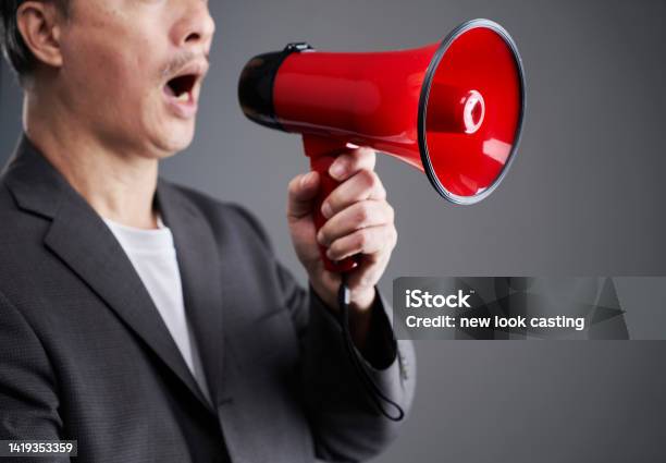 Chinese Ethnicity Businessman Holding Red Megaphone Stock Photo - Download Image Now