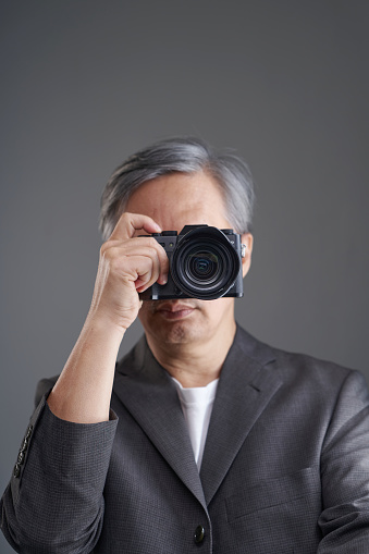 professional photographer with business wear holding camera