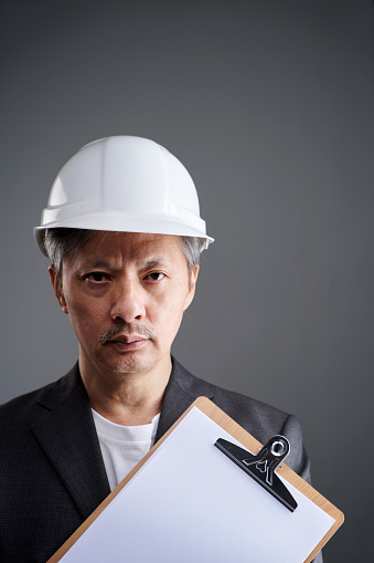 Portrait shot of a businessman wearing construction  helmet
