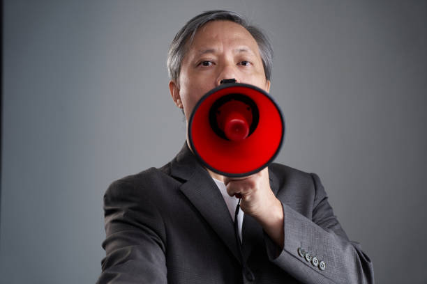 chinese ethnicity businessman holding  red megaphone