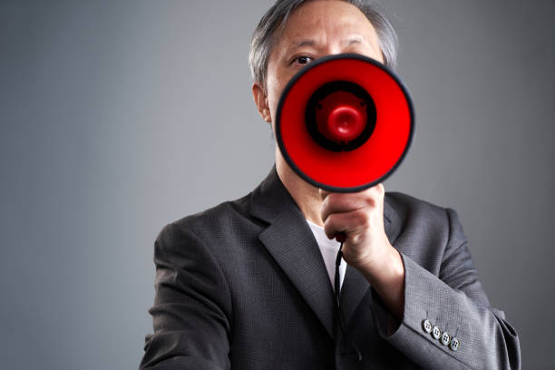 istock chinese ethnicity businessman holding  red megaphone 1419354152