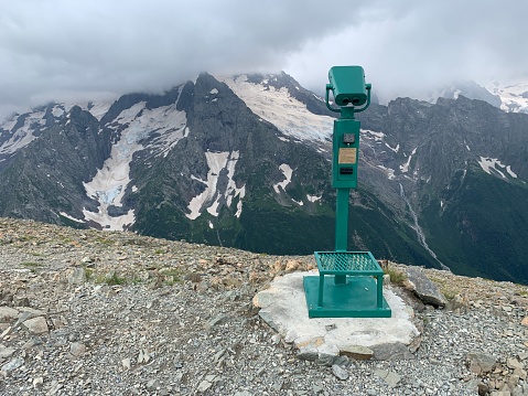 Coin operated electronic binoculars for tourists on a mountain landscape