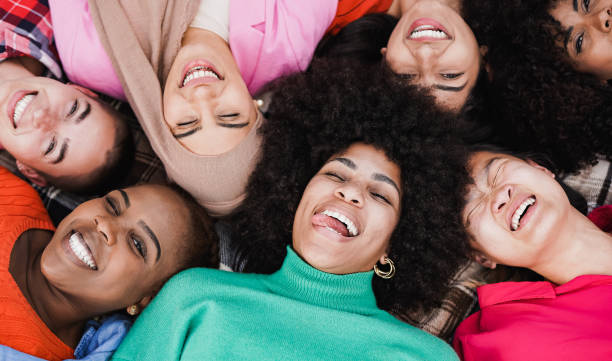 group of multiethnic women having fun together at city park - female friendship and diversity concept - life events laughing women latin american and hispanic ethnicity imagens e fotografias de stock