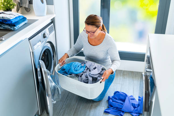 istock Woman with laundry basket loading the washer 1419360570