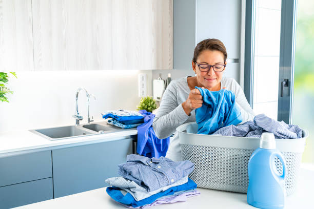 istock Woman smelling laundry after wash machine 1419360950