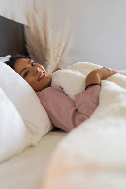 istock young latina enjoys her quiet time lying in bed 1419363319
