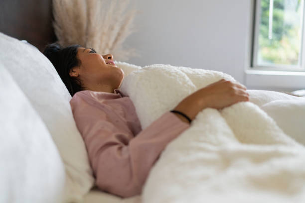 istock young latina enjoys her quiet time lying in bed 1419363378