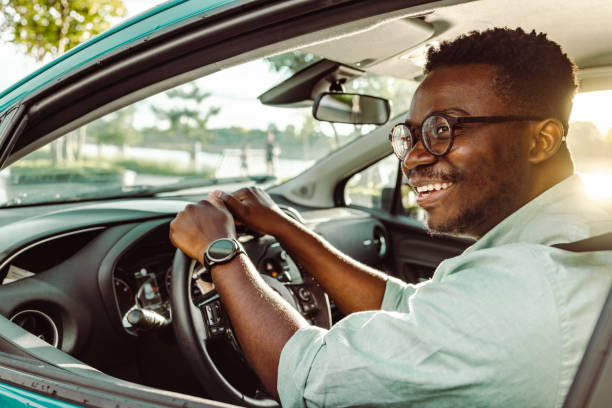 istock Happy male driver holding steering wheel and driving a car 1419363447