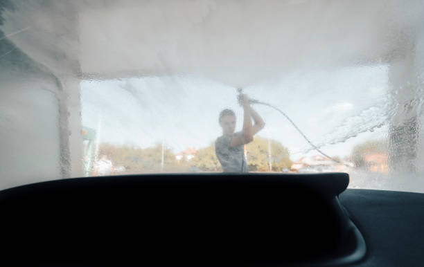 istock Young man washing car 1419365304