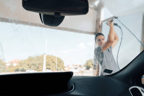 istock Young man washing car 1419365990