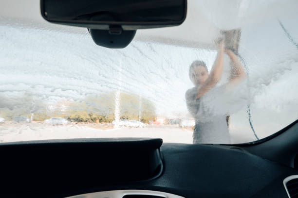 istock Young man washing car 1419366005