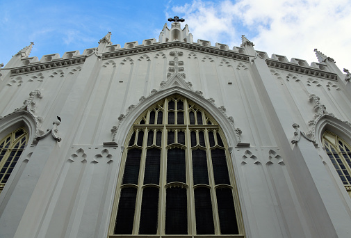 Crosses decorate the arch over entry doors of the Clayborn Temple in Memphis Tennessee.  Ivy grows on left side of window.
