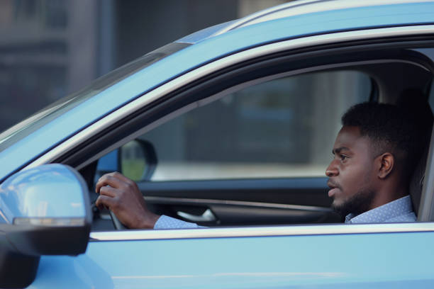 istock Serious African American driver sits in car cabin 1419366485