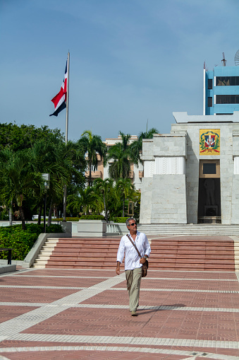 Mature man walking through the city at El Altar de la Patria in Santo Domingo, Dominican Republic.