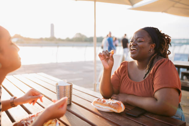 istock Two happy female friends having a lunch together 1419370342