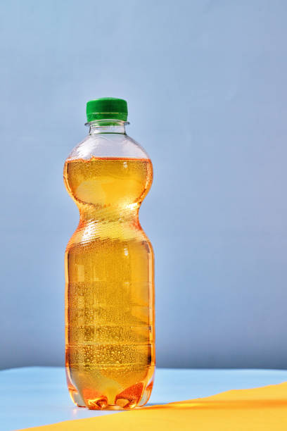 istock Plastic Bottle of Apple Soda on Vibrant Background 1419370865