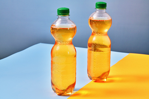 Plastic Bottle of Apple Soda on Vibrant Background