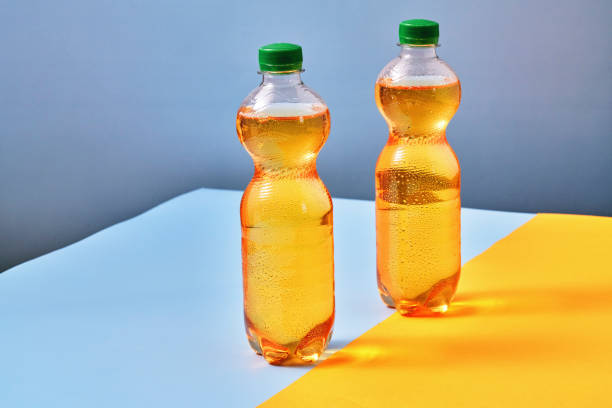 istock Plastic Bottle of Apple Soda on Vibrant Background 1419370897