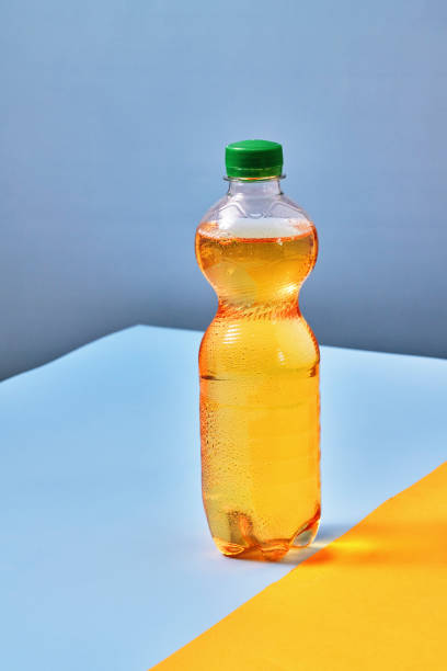 istock Plastic Bottle of Apple Soda on Vibrant Background 1419370902