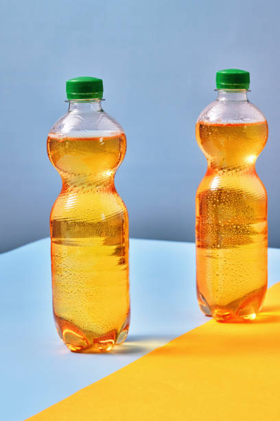 istock Plastic Bottle of Apple Soda on Vibrant Background 1419370911