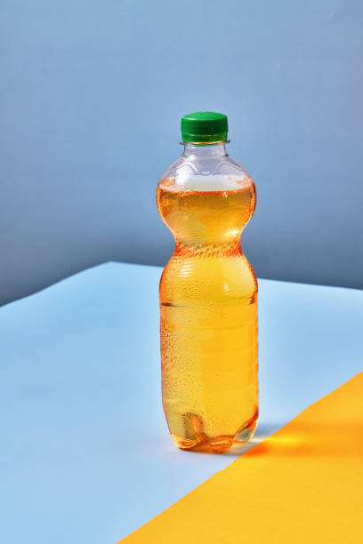 istock Plastic Bottle of Apple Soda on Vibrant Background 1419370935