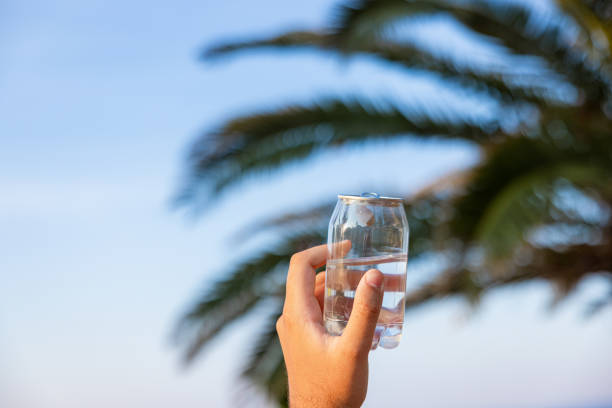 istock Unrecognizable man holding plastic can with water, with a nature as a background 1419371049