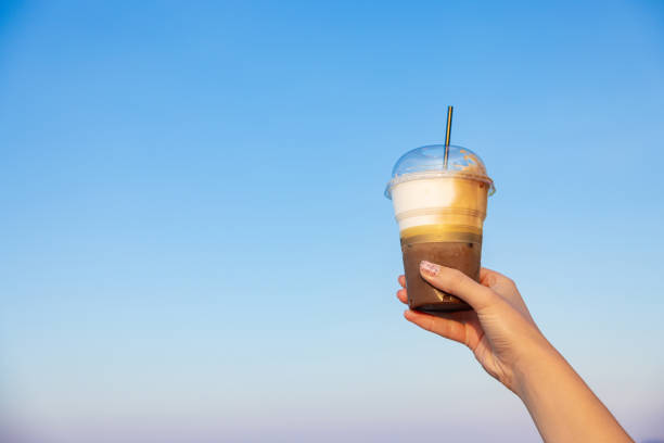 istock Unrecognizable woman holding plastic cup woth iced coffee 1419371645
