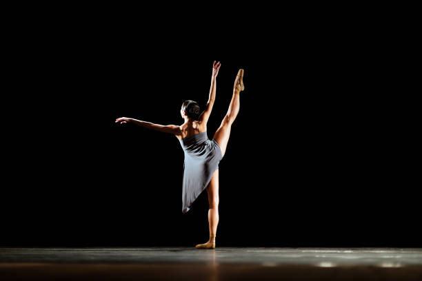 istock Girl dancing neoclassic ballet on dark stage 1419376169