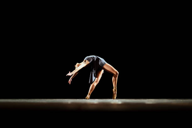 istock Girl dancing neoclassic ballet on dark stage 1419376171