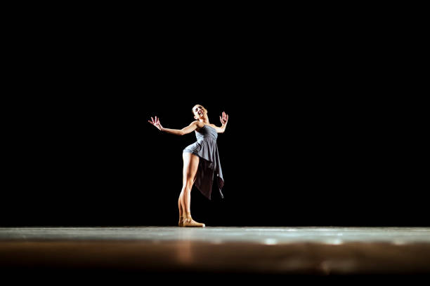 istock Girl dancing neoclassic ballet on dark stage 1419376174