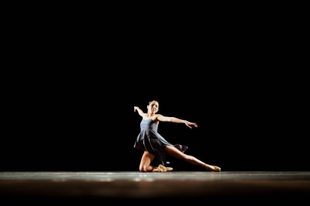 istock Girl dancing neoclassic ballet on dark stage 1419376185