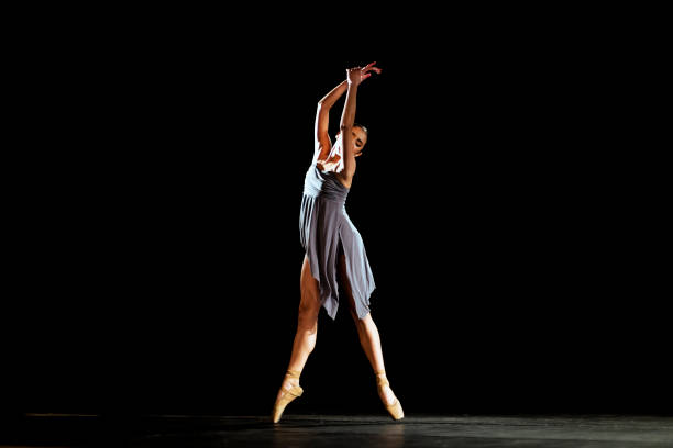 istock Girl dancing neoclassic ballet on dark stage 1419376188