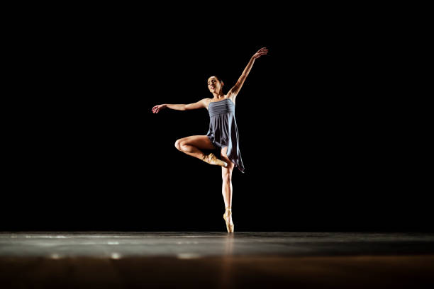 istock Girl dancing neoclassic ballet on dark stage 1419376204
