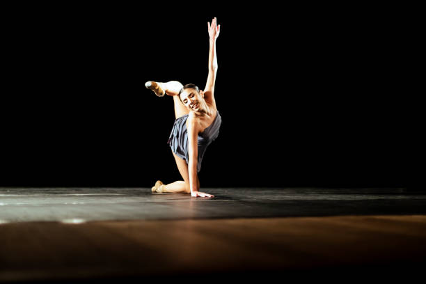 istock Girl dancing neoclassic ballet on dark stage 1419376229