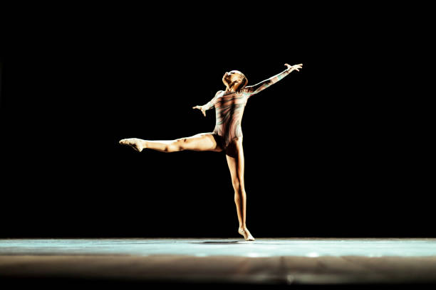 istock Girl performing contemporary dance on dark stage 1419376276