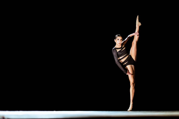 istock Girl performing contemporary dance on dark stage 1419376349
