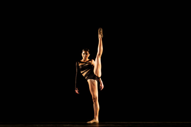 istock Girl performing contemporary dance on dark stage 1419376367