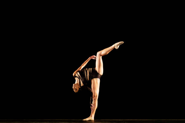 istock Girl performing contemporary dance on dark stage 1419376371