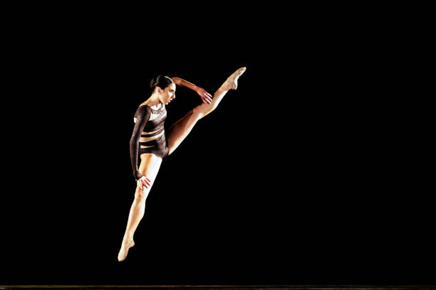 istock Girl performing contemporary dance on dark stage 1419376374