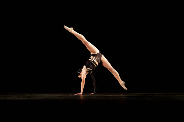 istock Girl performing contemporary dance on dark stage 1419376390