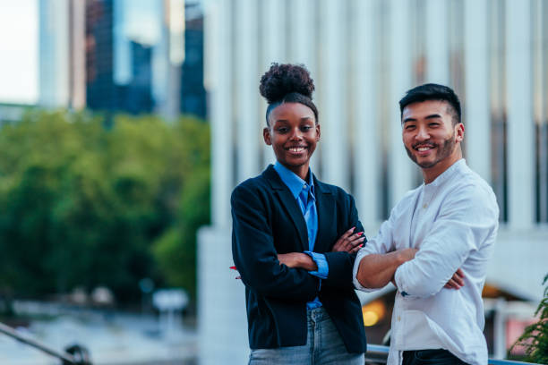 african americana and asian businesspeople smiling at camera - chinese ethnicity latin american and hispanic ethnicity multi ethnic group business person imagens e fotografias de stock