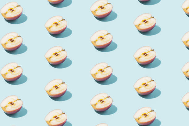istock Creative summer background of apple halves on a blue background. Minimal summer concept. 1419377685