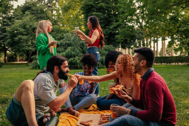 istock Multiracial friends at picnic on a sunny afternoon 1419378103
