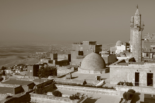 Photo with sepia effect of the panoramic view of the city buildings and Mesopotamian valley in light haze on the background