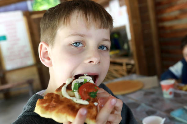 istock Child eating adyghe pita bread 1419381160